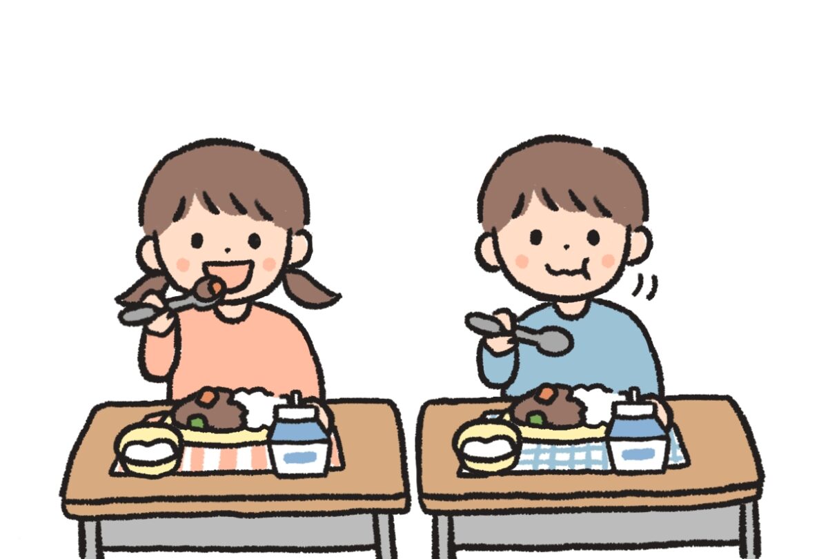 給食を食べる男女2人の児童のイラスト